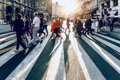 An illustrative photo of a group of people walking on pedestrian lane