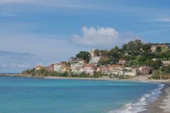 An illustrative photo of houses near sea.