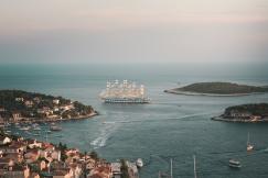 An illustrative photo of white and brown galleon ship on body of water.