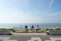 An illustrative photo of a couple of people sitting on a bench.