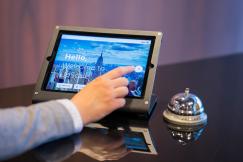 An illustrative photo of a person touching black tablet