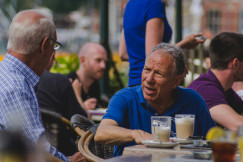 An illustrative photo of two old men drinking coffee on the streets of Amsterdam
