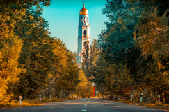 An illustrative photo of a building near green trees.