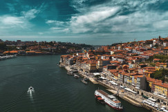 An illustrative photo of a boat floating next to the city