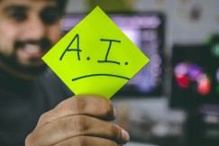 An illustrative photo of a person holding a green piece of paper.