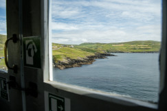 An illustrative photo of a view of a body of water through a window.