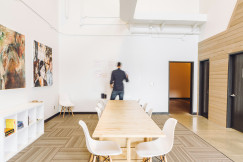 An illustrative photo of a man standing in a room.