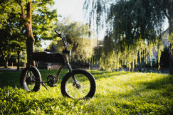 An illustrative photo of a black and gray motorcycle on green grass field