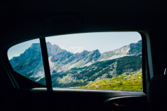 An illustrative photo of a view of mountains from inside a car.