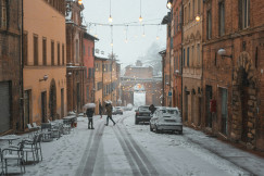 An illustrative photo of a couple of people walking down a snowy street.
