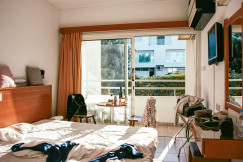 An illustrative photo of bedroom with bed and window.
