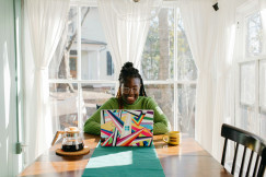 An illustrative photo of a woman sitting at a table.