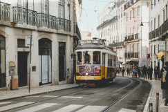 An illustrative photo of a cable train in between high-rise building at daytime