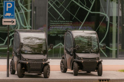 An illustrative photo of a couple of cars parked next to each other on a street.