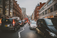 An illustrative photo of wide road with vehicles