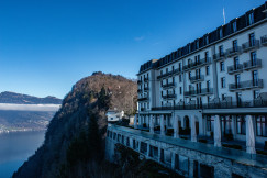 An illustrative photo of a building on a cliff overlooking a body of water
