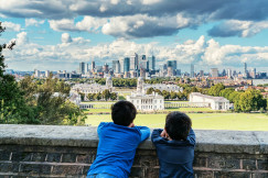 An illustrative photo of two boys looking at a city