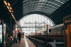 An illustrative photo of people standing near train.
