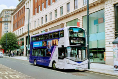 An illustrative photo of a double decker electric bus parked on the side of the street