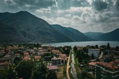 An illustrative photo of a scenic view of a town with mountains in the background