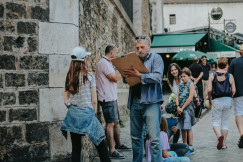 An illustrative photo of a street artist drawing a girl in Paris