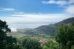 An illustrative photo of a view of a valley and a body of water