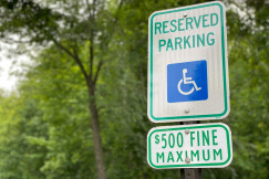 An illustrative photo of a sign with a symbol of parking for disabled