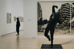 An illustrative photo of people standing in a gallery.