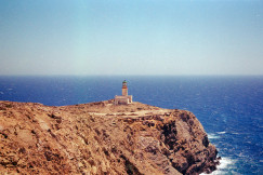 An illustrative photo of a lighthouse on a cliff.