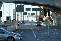 An illustrative photo of a car driving down a street.