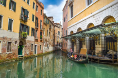 An illustrative photo of a boat on river between buildings