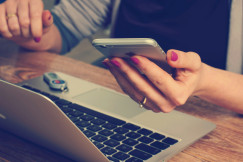woman holding a silver phone