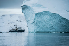 Photo by Unsplash An illustrative photo of a boat beside an iceberg