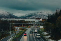 An illustrative photo of cars and mountains.