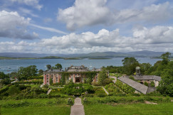 An illustrative photo of several buildings on a coast near a body of water