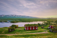 An illustrative photo of farm house near a body of water