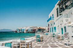 An illustrative photo of white buildings on a coast near a body of water