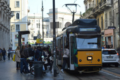 An illustrative photo of a yellow and black bus on a city street