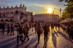An illustrative photo of people walking on a square during sunny weather