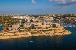 An illustrative photo of buildings on a coast near a body of water