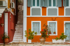 An illustrative photo of an orange concrete building in Greece