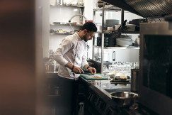 An illustrative photo of a chef cooking on a restaurant kitchen