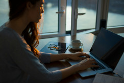 An illustrative photo of a woman with a laptop.