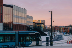 An illustrative photo of a tram driving down a snow covered street.