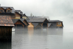 An illustrative photo of wooden houses in water.