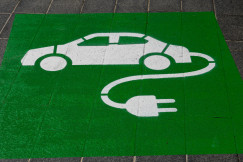 An illustrative photo of a green and white electric car sign.
