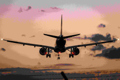An illustrative photo of a plane landing during sunset.