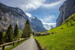 An illustrative photo of road near green hill in the mountains.