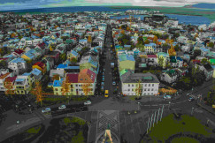 An illustrative photo of multicoloured houses in a city.
