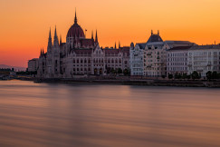 Image by Unsplash An illustrative photo of the Hungarian Parliament building near a river during sunset.